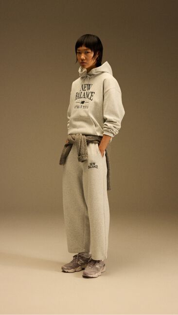 Head to toe image of a model wearing the tan and beige shoes 