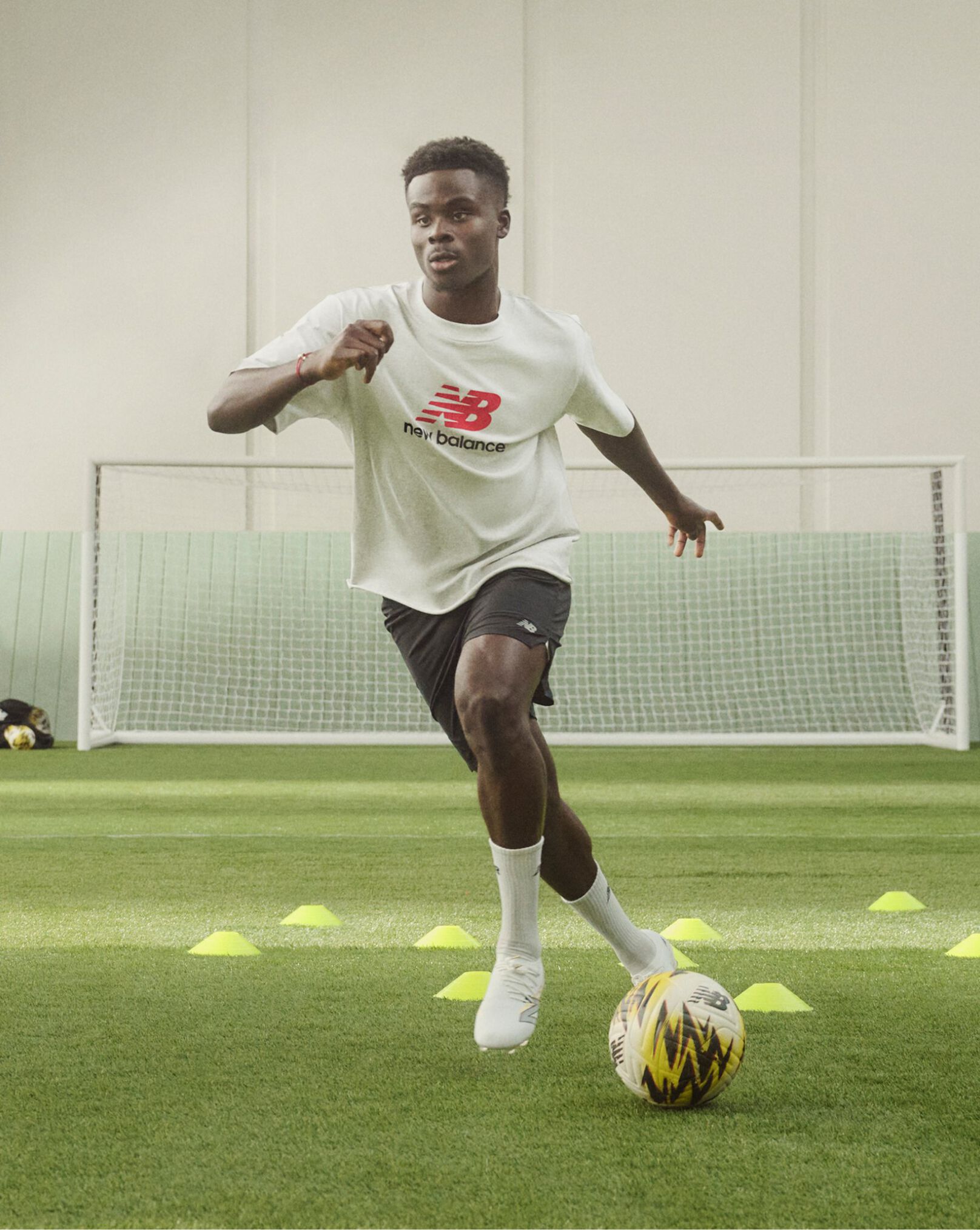 Soccer player dribbling through cones on a soccer field
