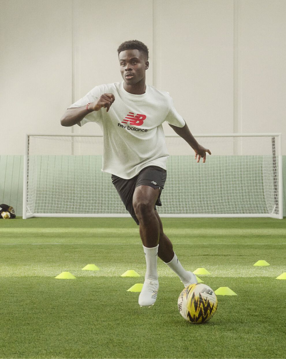 Soccer player dribbling through cones on a soccer field