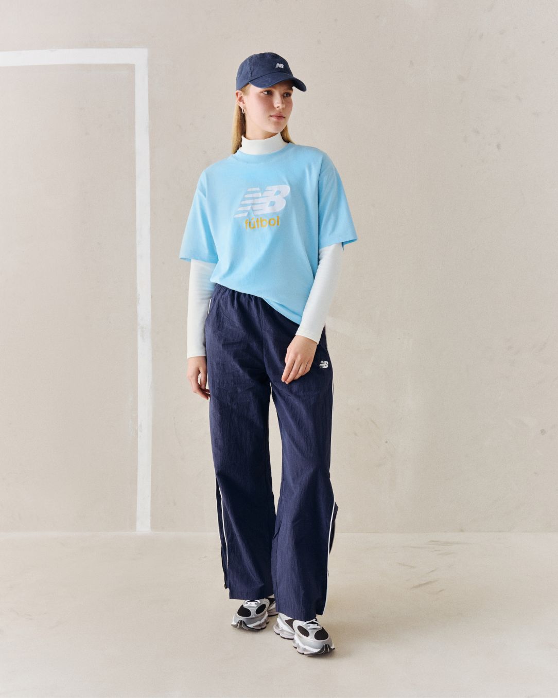 A person wearing a blue soccer graphic tee.