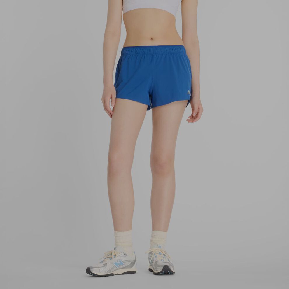 Person wearing blue New Balance shorts.