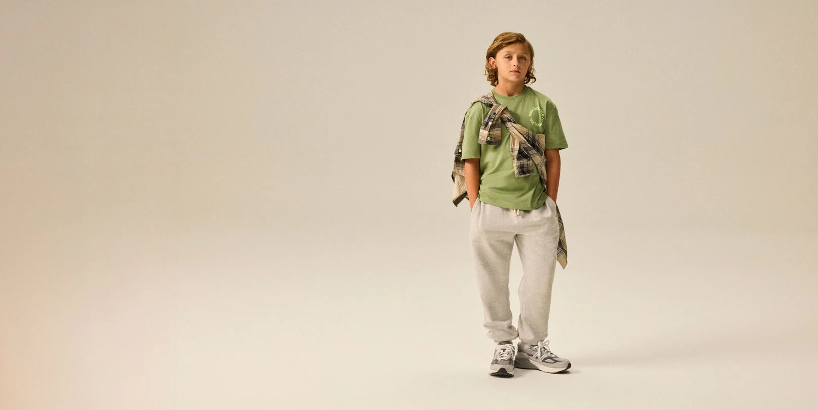 Boy wearing a pair of 990v6&nbsp;shoes.