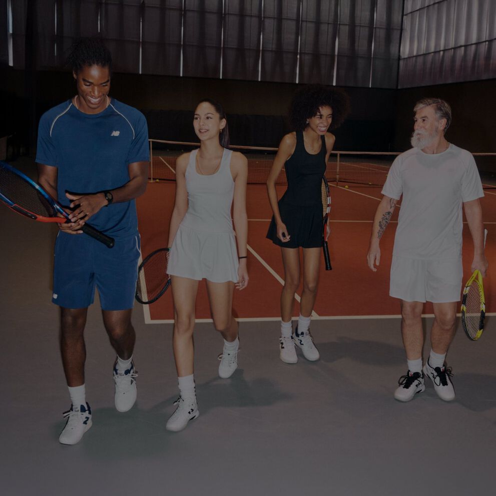 Two tennis players walk together on an indoor court.