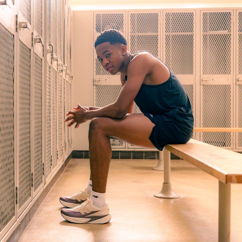 Quincy Wilson sitting on a bench in a locker room