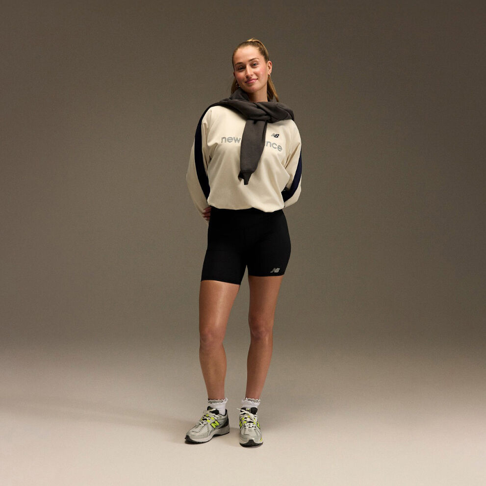 Jordyn Huitema standing with an athletic outfit in front of a brown and tan background.