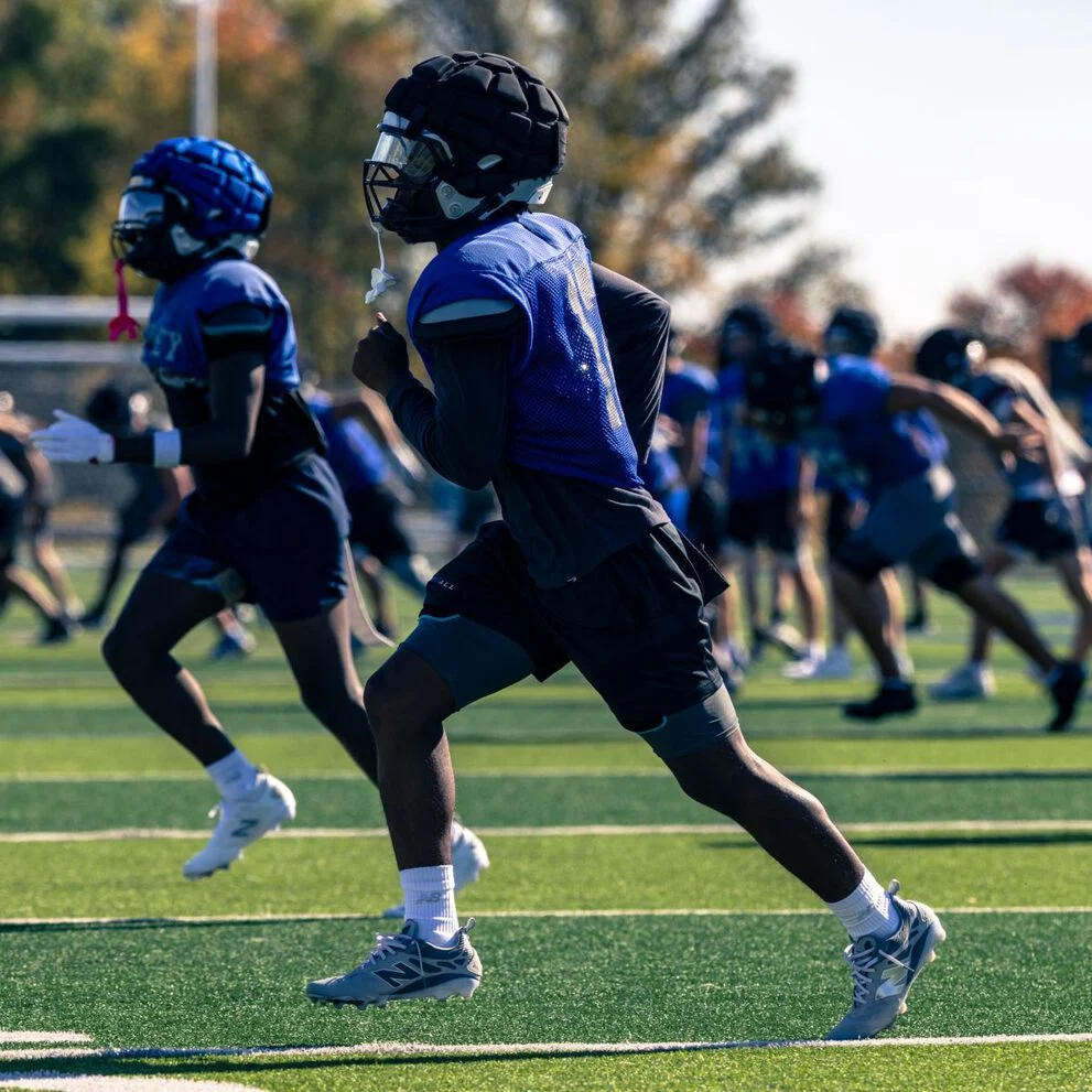 High school football players on a field.