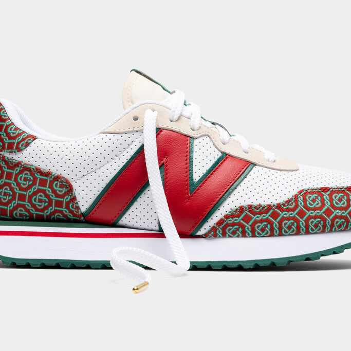 A close-up crop of the side of a white, red, and green NB x Casablanca 237 sneaker