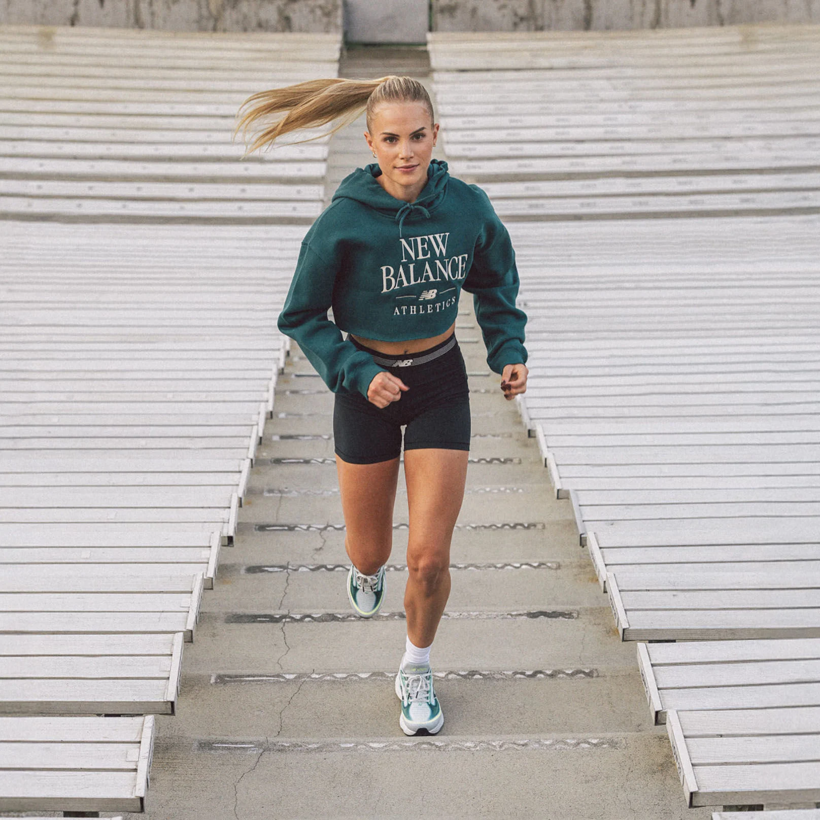 Parker Valby running up bleacher stairs