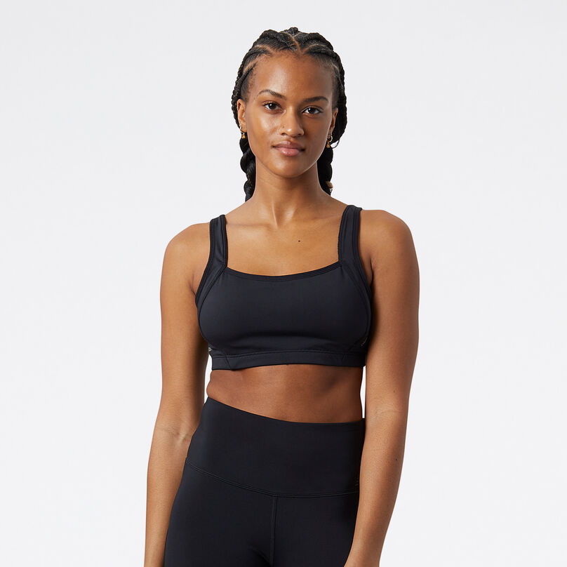 Woman wearing a black NB Breakthrough Bra looking at the camera in a studio environment.