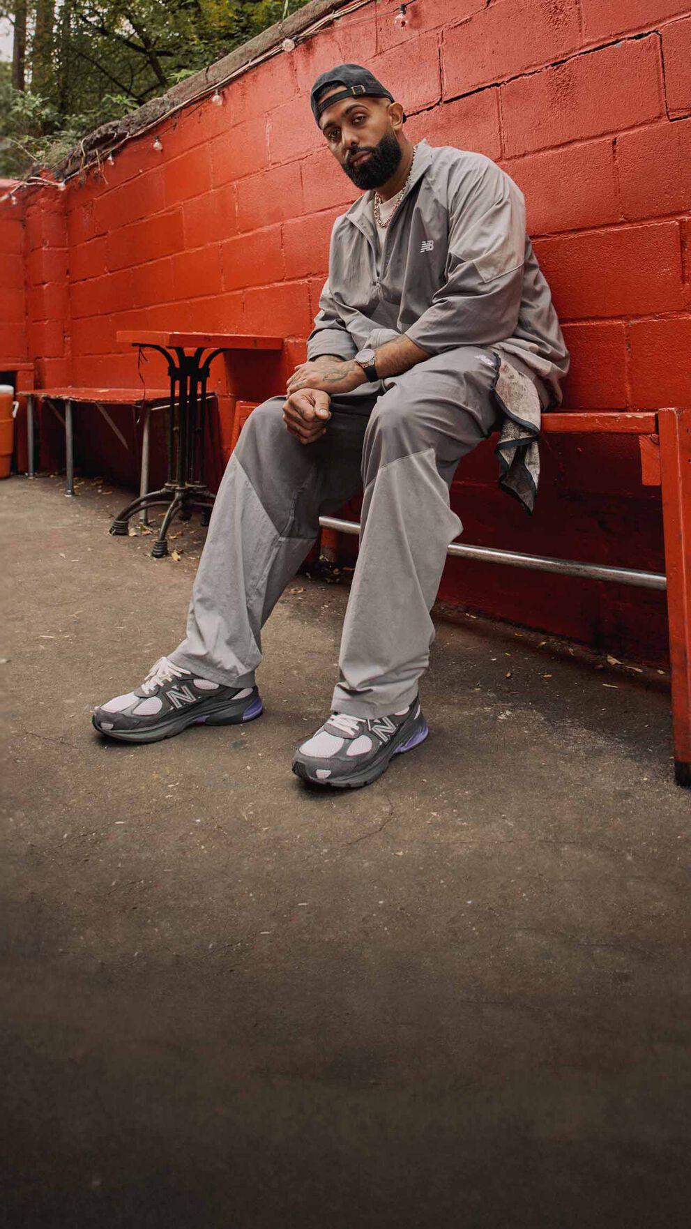 A head to toe shot of Eladio Carri&oacute;n sitting down while wearing the ABZORB 2010 shoe. 
