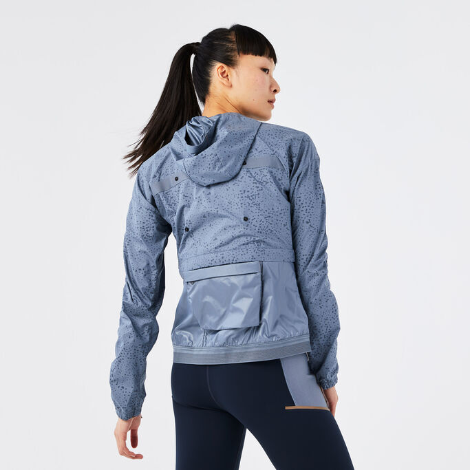 Young woman with her back turned to show the storage on the back of the jacket.