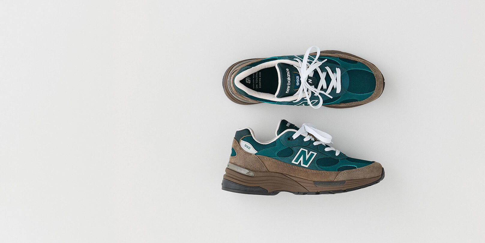 Two green and brown shoes on a white background