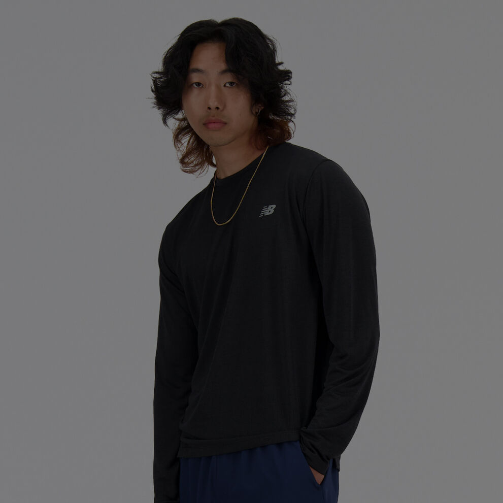 Homme vêtu d'un t-shirt New Balance noir à manches longues.