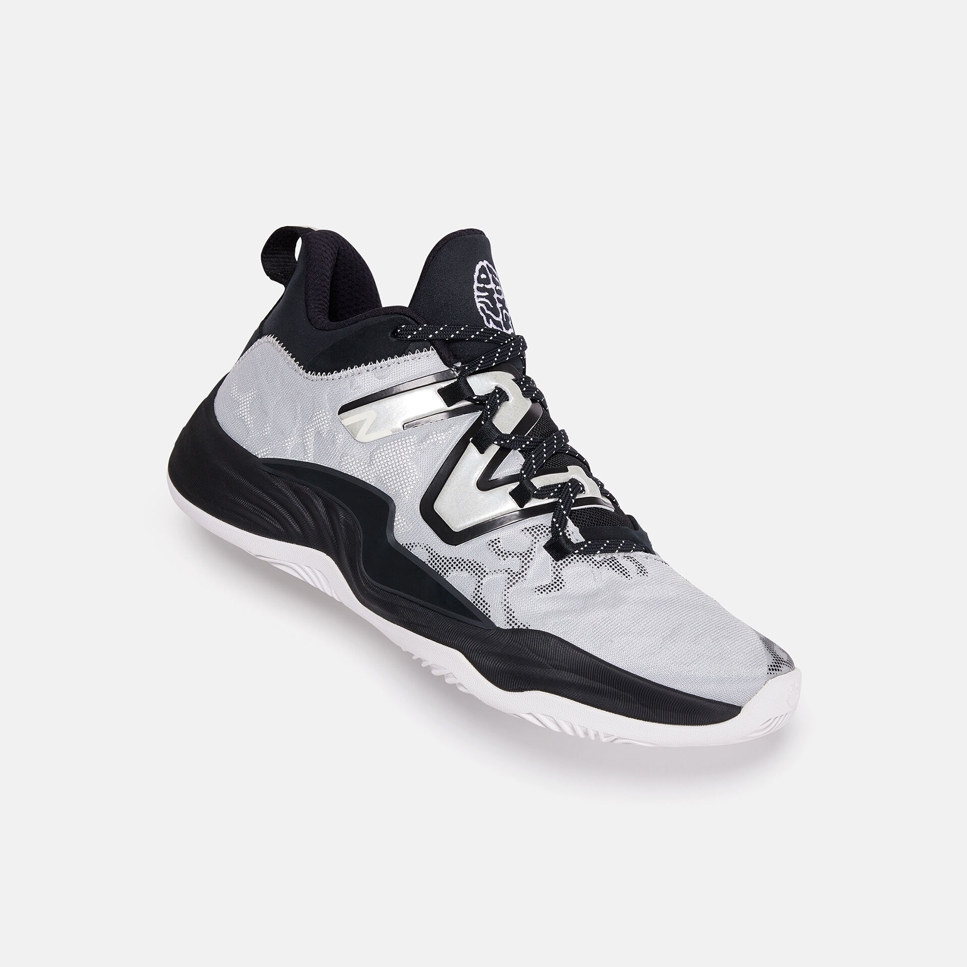 Black and white basketball shoe laying on its side on a grey background.