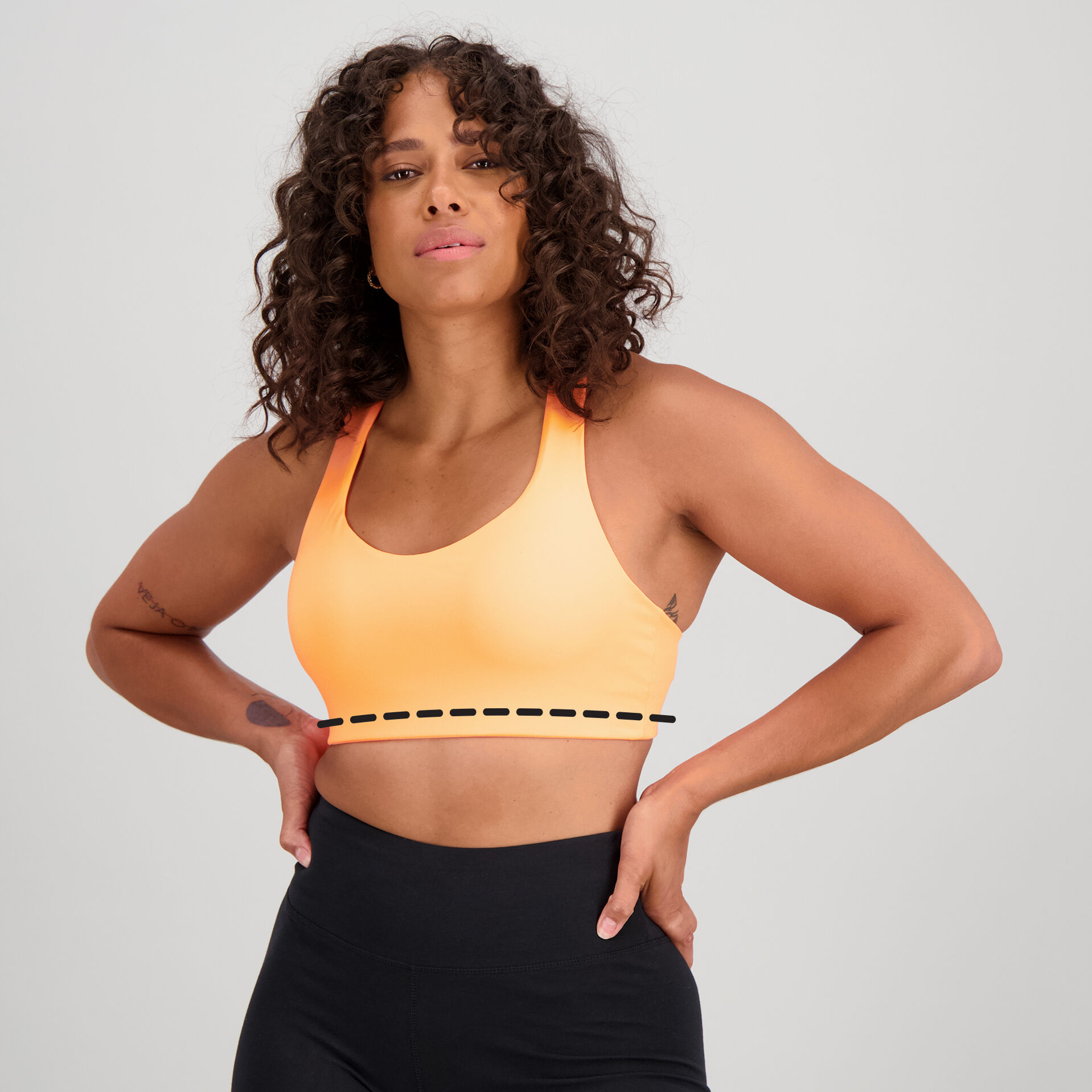 Woman wearing an orange NB Power X Bra