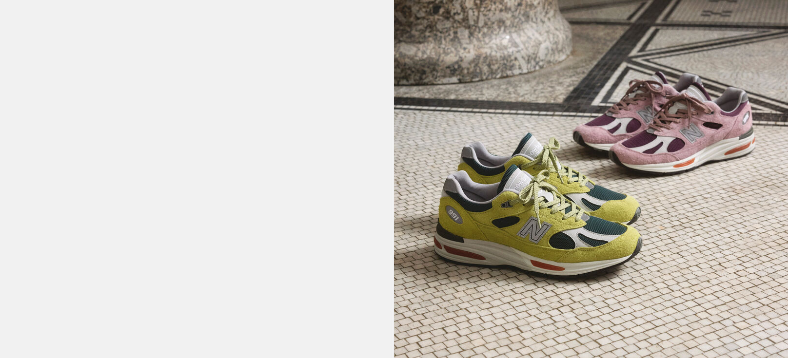 Two pairs of New Balance Made in UK sneakers on a textured white tiled floor. 