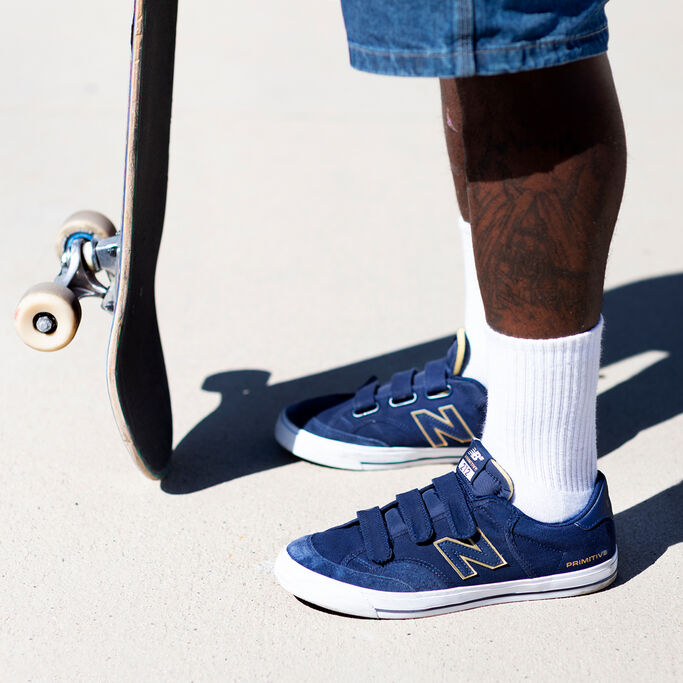 Knee down crop of Skateboarder Tre Williams wearing Numeric 212 shoes with white crew socks and denim shorts