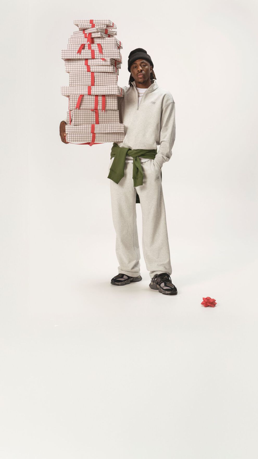 Athlète de soccer debout dans un ensemble blanc assorti, tenant des cadeaux.