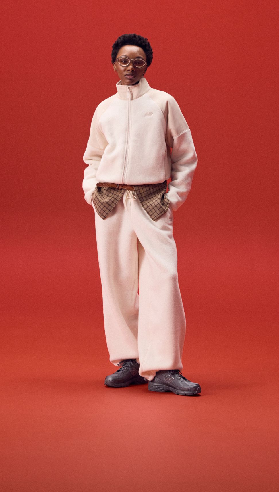 Young woman in a white outfit and black shoes.