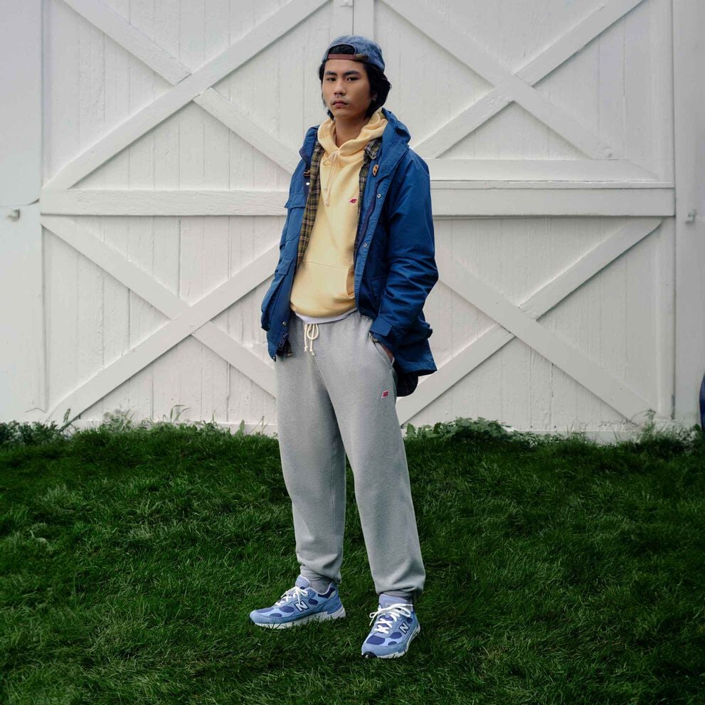 A man standing in front of set of white barn doors.