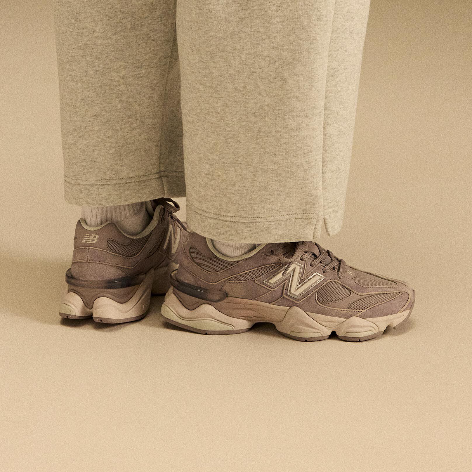 Side profile on-figure shot of the tan and beige shoes.