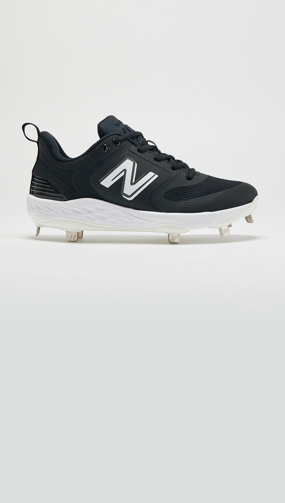 Profile view of an all black softball cleat. 