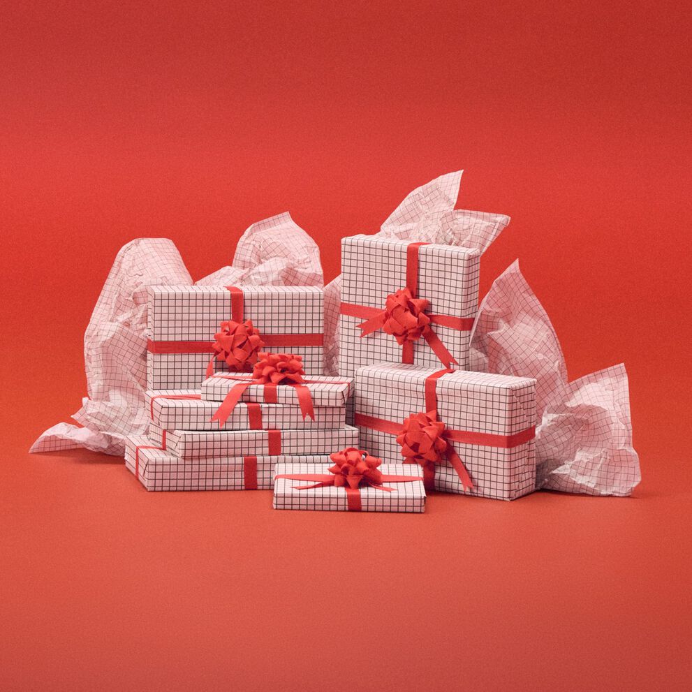 White present boxes in front of a red backdrop.