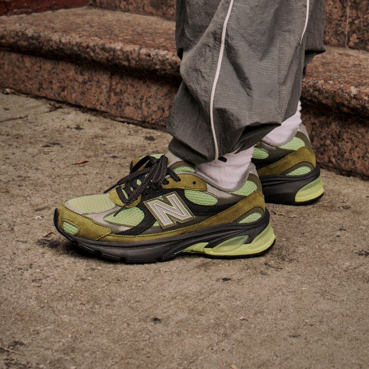   Side profile on figure shot of green, brown and black sneakers.