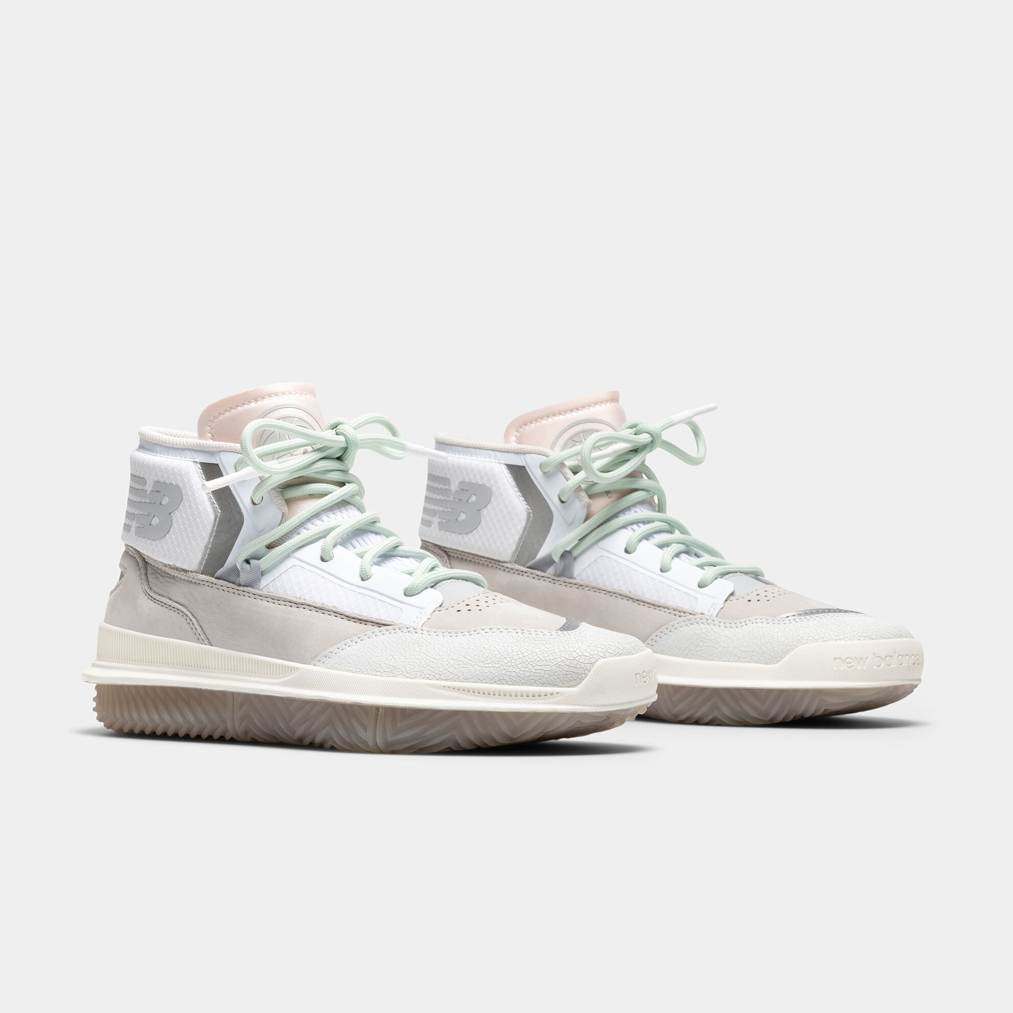 Pair of neutral BB9000 basketball shoes on grey studio background