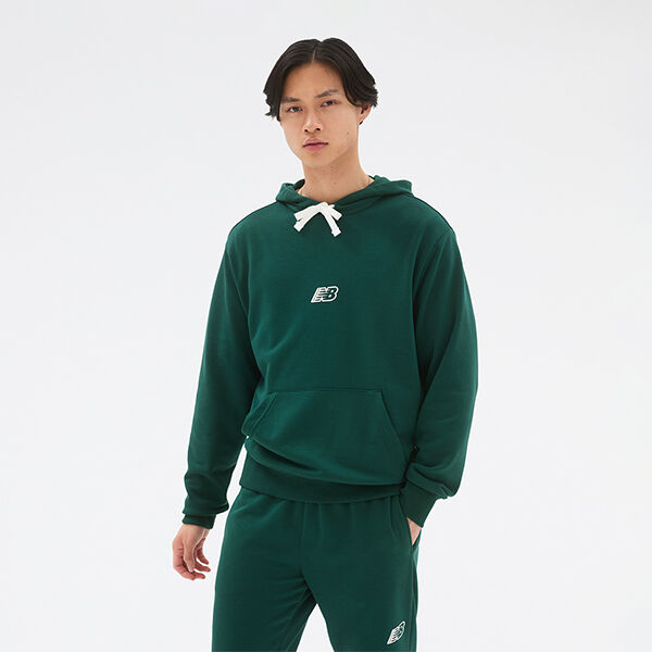 Man wearing matching dark green NB hoodie and sweatpants