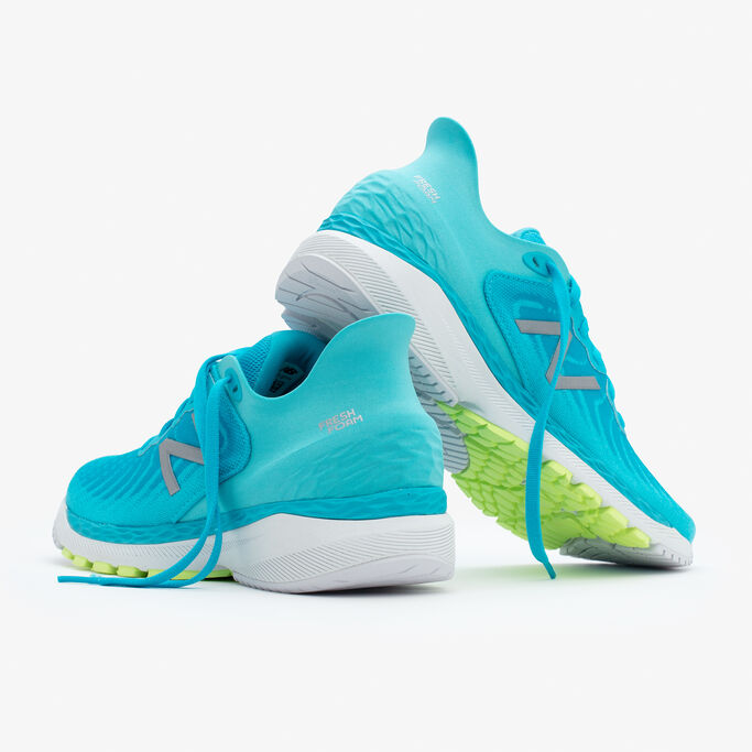 Two shoes facing backwards, one leaning up against the other on the heel