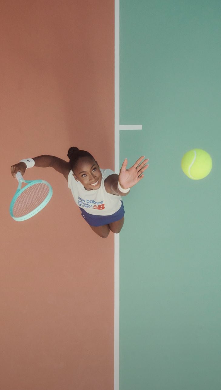 Coco Gauff throwing a tennis ball into the air