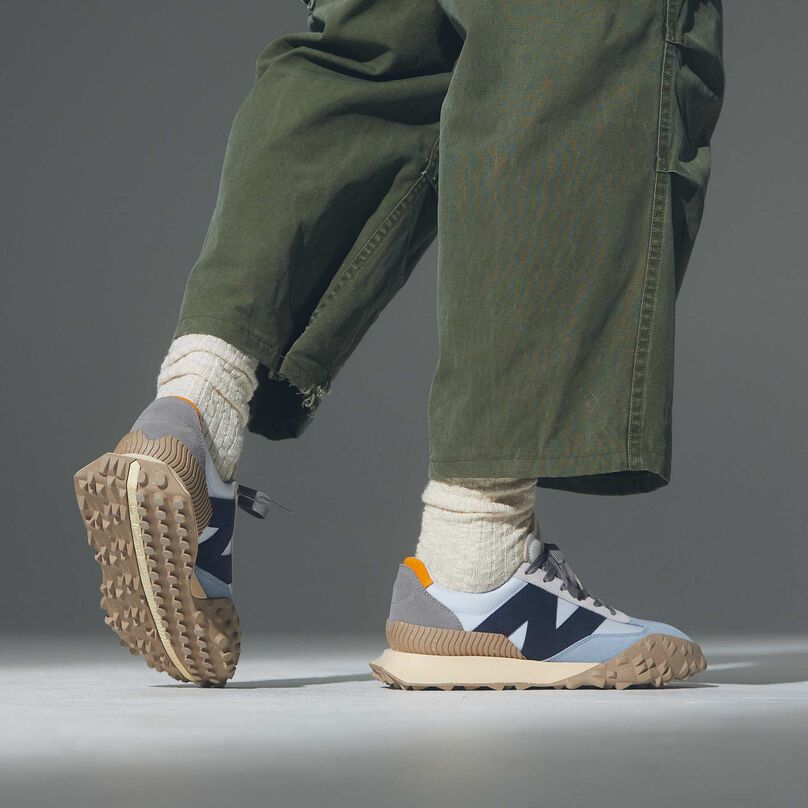 Model from the knees down wearing blue XC-72 shoes.