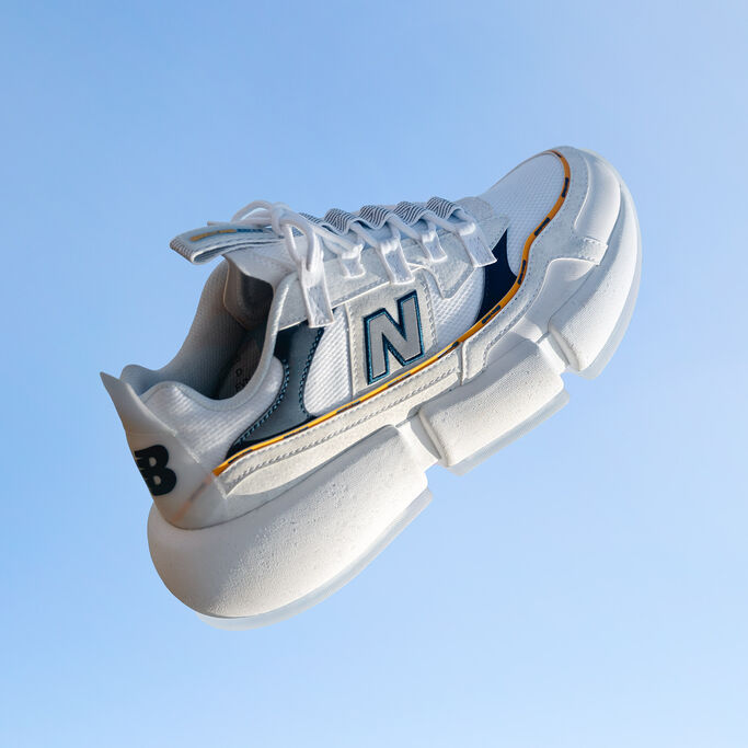 White Vision Racer shoe floating on blue background