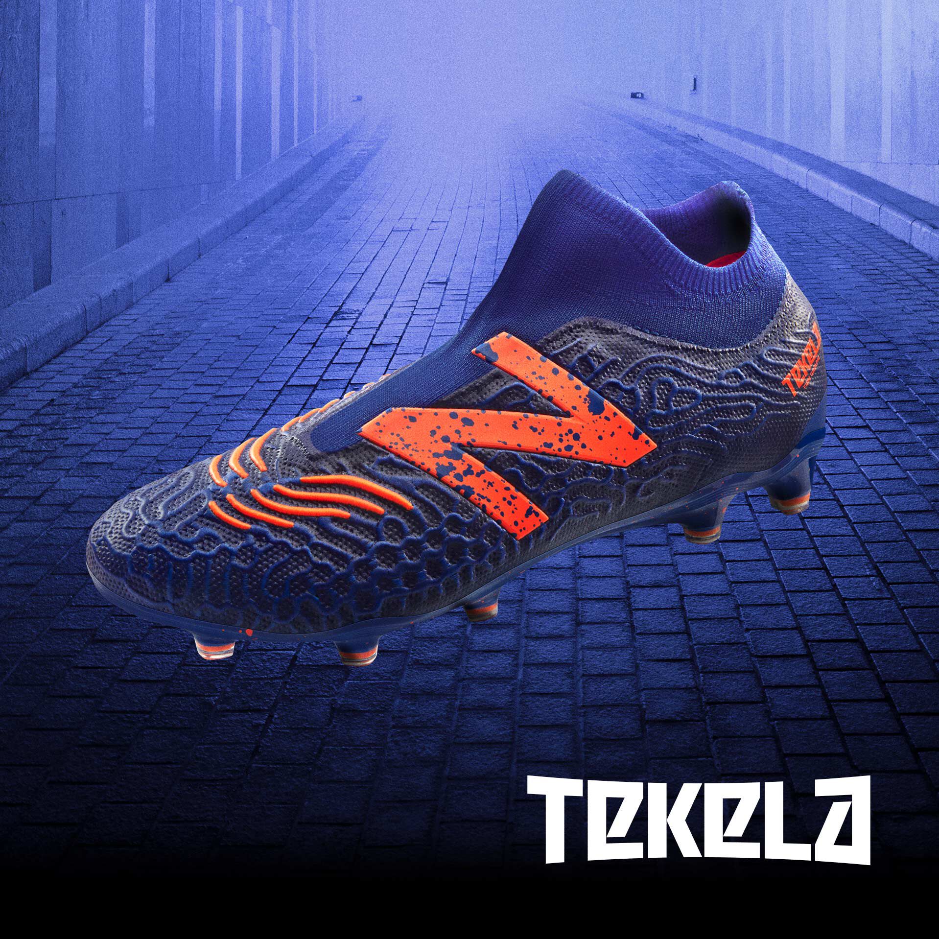 Single blue and orange Tekela cleat suspended in air over industrial backdrop with Tekela logo.