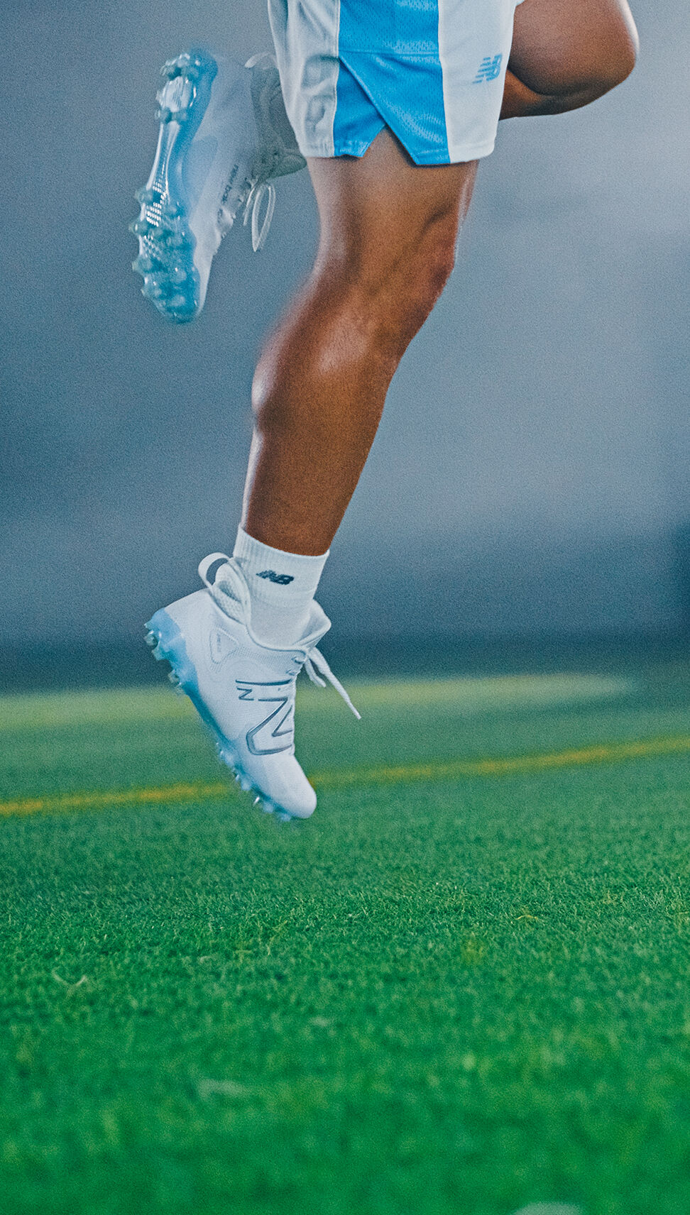 Lax player in motion jumping in the air.