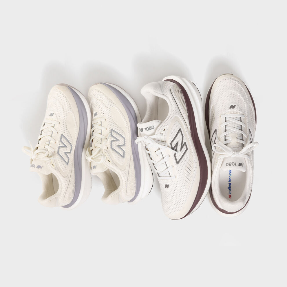 Two pairs of 1080 shoes on a grey background.
