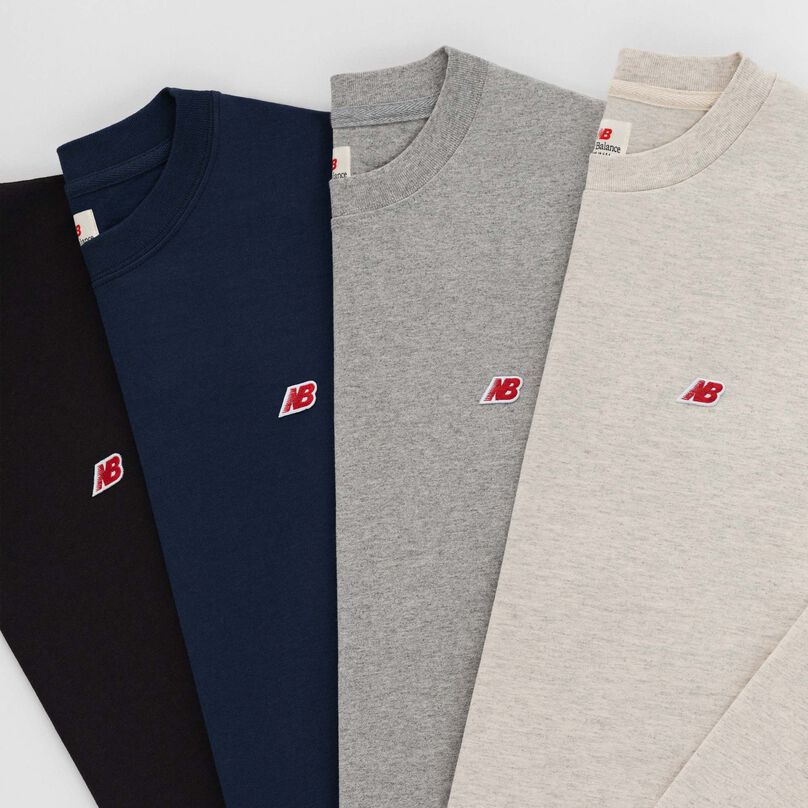 Grouping of MADE In USA long sleeve shirts stacked on top of each other.