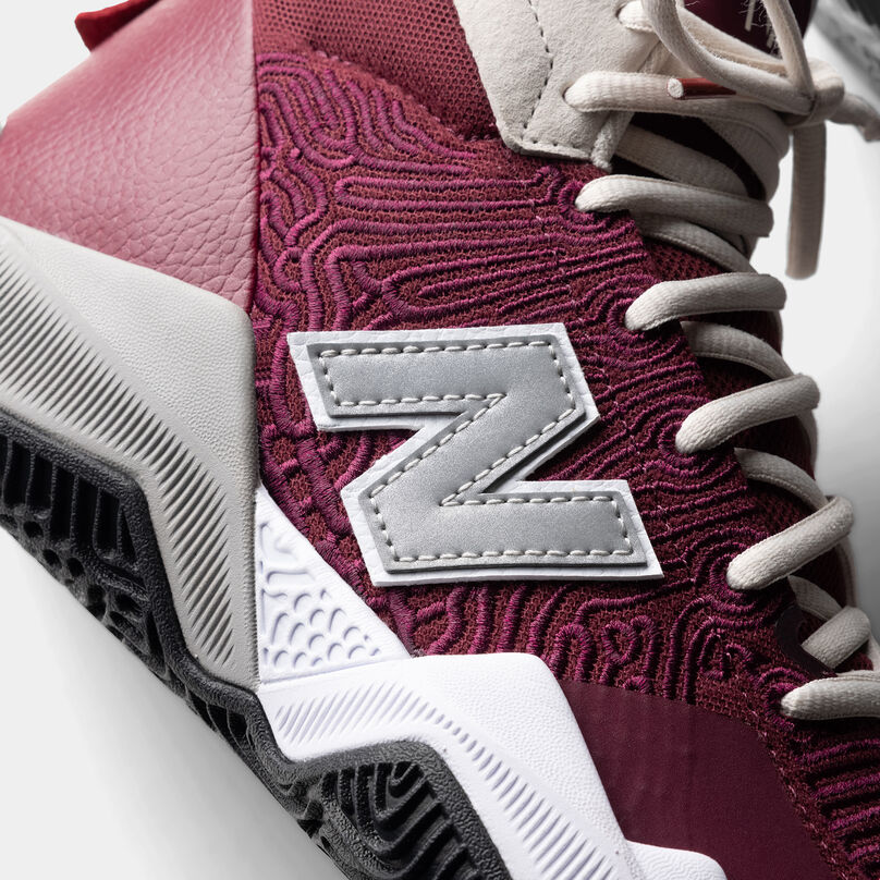 Cropped side profile of the burgundy TWO WXY basketball shoe, with grey N in the center