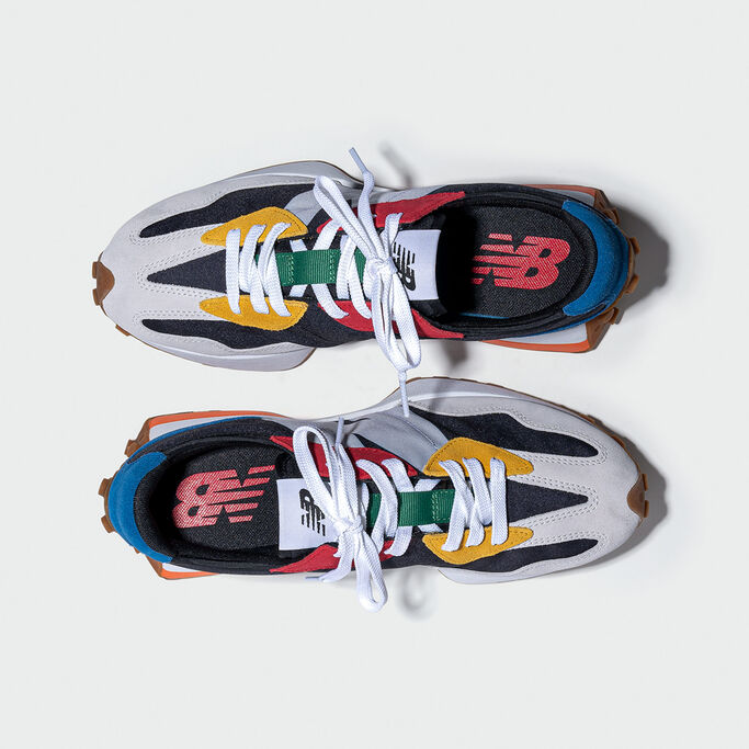Overhead view of a pair of multicolor men’s NB 327 sneakers on a light grey background