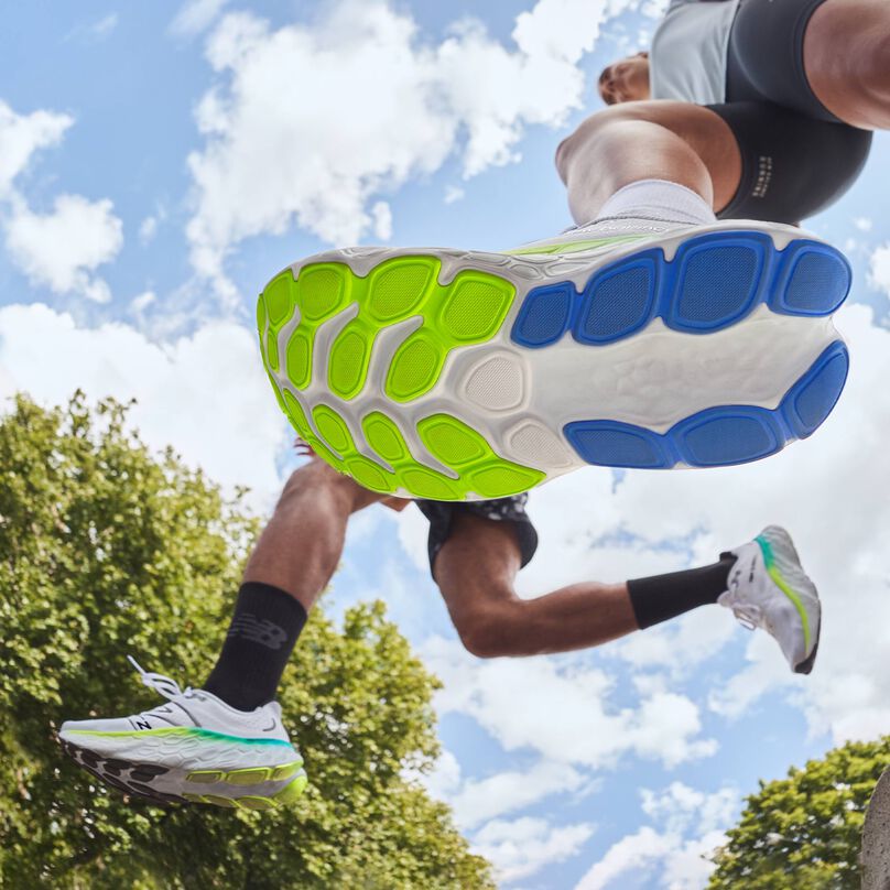 Bottom of sole view while 2 people are running in Fresh Foam More v4 shoes.