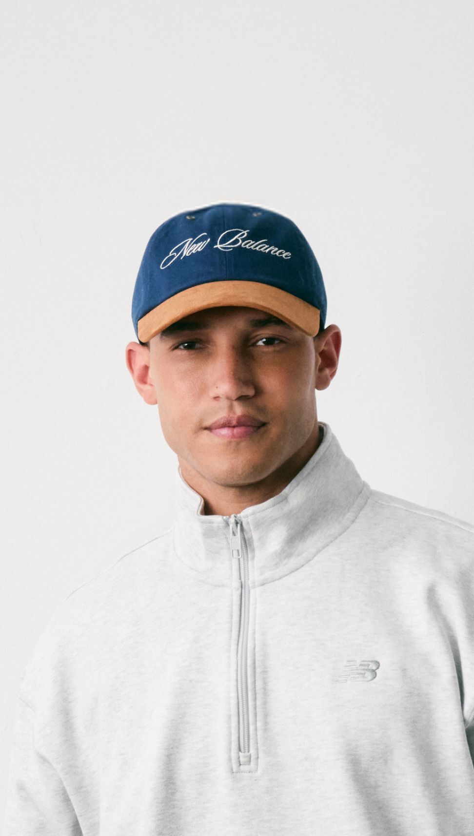 A man wearing a ‘47 New Balance hat in studio.